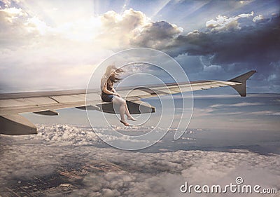 Woman on airplane wing Stock Photo