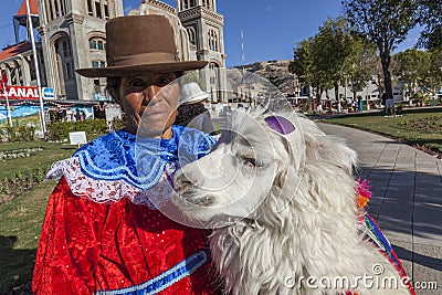 Woman with alpaaca at central square of Huaraz Editorial Stock Photo