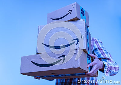 Woman with Amaozn Prime cardboard parcels in hands Editorial Stock Photo