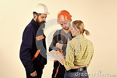 Woman amend plan of repair. Supervisor not satisfied with renovation. Misunderstanding concept. Brigade of workers Stock Photo