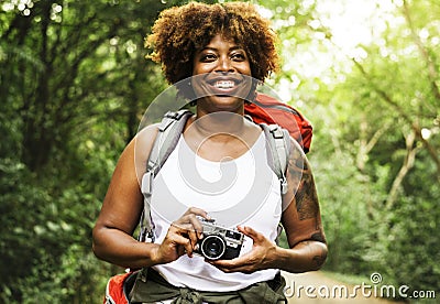 Woman with an analog camera in the forest Stock Photo