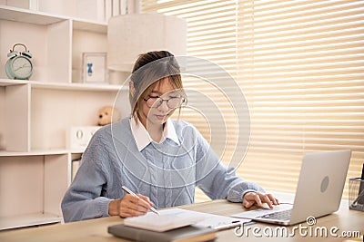 Woman analyzes data graphs, Works intently in his personal office Stock Photo