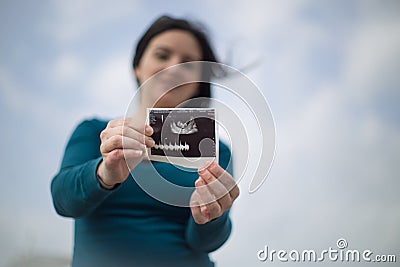 Single Woman announced pregnancy outdoors Stock Photo