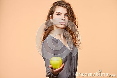 Woman with apple biege background Stock Photo