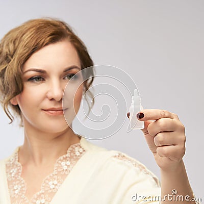 Woman apply eye drops. Girl glaucoma treatment Stock Photo