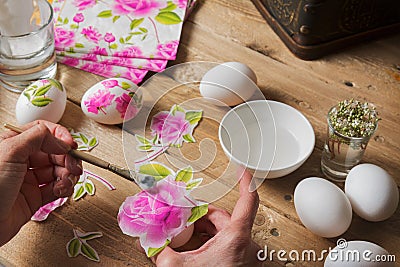 Woman apply glue on colored Easter egg, technique of decoup Stock Photo