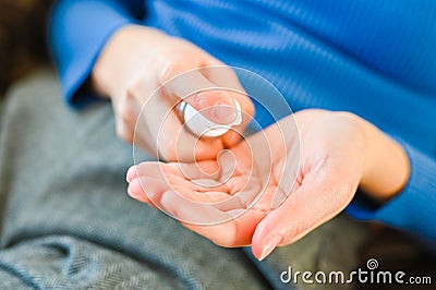 Woman applying antiseptic gel at home, closeup. Infection preventenion concept. Pandemic Coronavirus Stock Photo