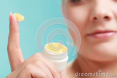 Woman applying balsam for lips Stock Photo