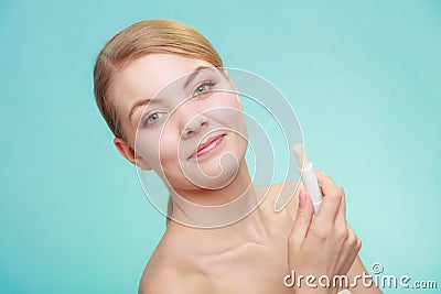 Woman applying balsam for lips Stock Photo