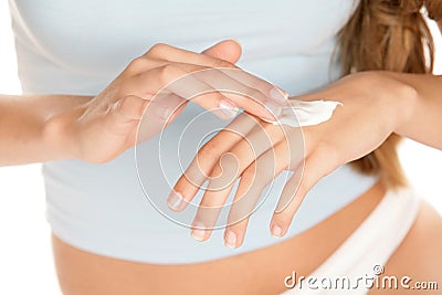 Woman applying cream on hands Stock Photo