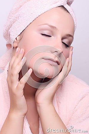 Woman applying creme on face Stock Photo