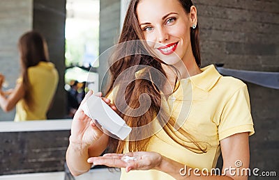 Woman applying dry shampoo on her hair Stock Photo