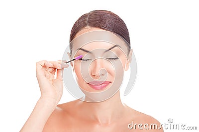 Woman applying eyelash serum essential oil on eyelashes with makeup mascara brush Stock Photo