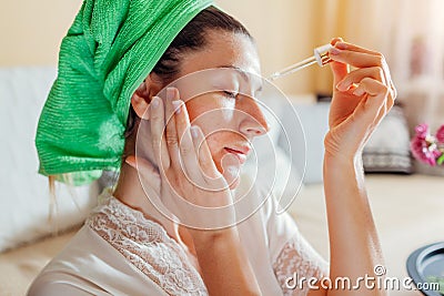 Woman applying facial hyaluronic acid serum. Skincare treatment. Product for oily skin with acne and large pores Stock Photo