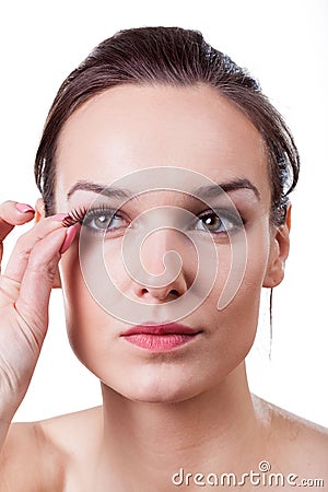 Woman applying fake eyelashes Stock Photo