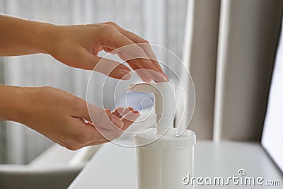 Woman applying hand sanitizer, closeup. Personal hygiene during COVID-19 pandemic Stock Photo