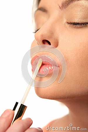 Woman applying lip gloss Stock Photo