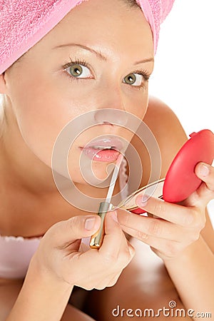 Woman applying lip gloss Stock Photo