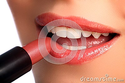 Woman applying lipstick beauty cosmetics to lips Stock Photo