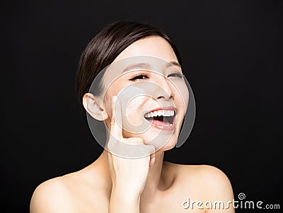 Woman applying lotion cream on face Stock Photo