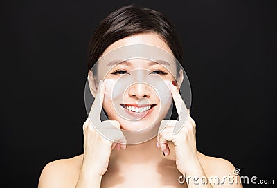 Woman applying lotion cream on face Stock Photo