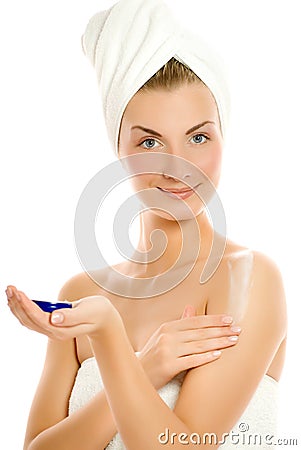 Woman applying moisturizer Stock Photo