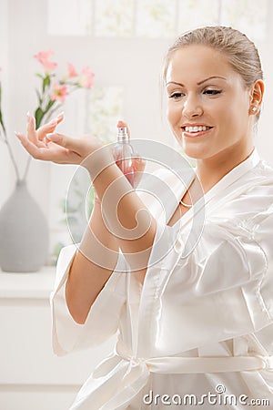 Woman applying perfume Stock Photo