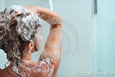 Woman applying shampoo in shower Stock Photo