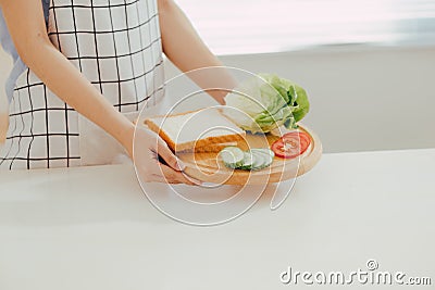 Woman apron preparing a breakfast in the kitchen Stock Photo