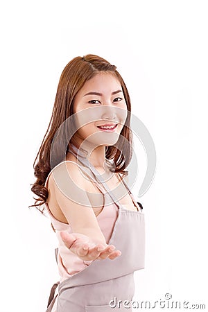 Woman with apron showing inviting hand Stock Photo