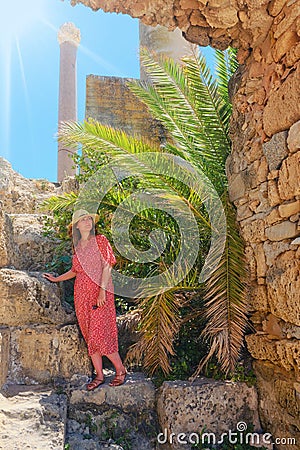 Woman among archaeological excavations at the base of Anthony terms, ancient roman building. Ruins of Carthage antique times of Stock Photo