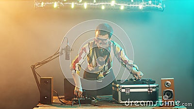 Woman artist mixing techno sounds with turntables Stock Photo