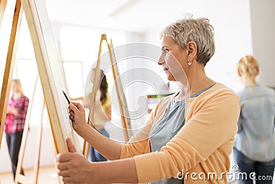 Woman artist with pencil drawing at art school Stock Photo