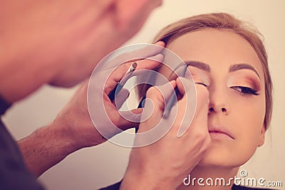 Woman in artist studio geting make up on Stock Photo