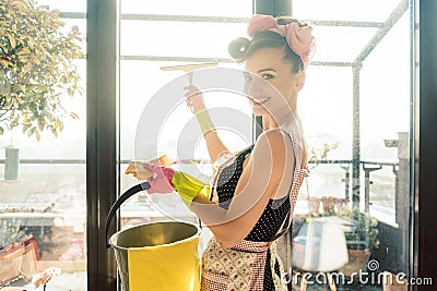 Woman as homemaker at spring clean working on the windows Stock Photo
