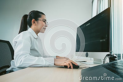 Woman asian software developers are analyzing together about the code written into the program on the computer in office room Stock Photo