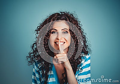 Woman asking for silence with finger on lips hush hand gesture Stock Photo