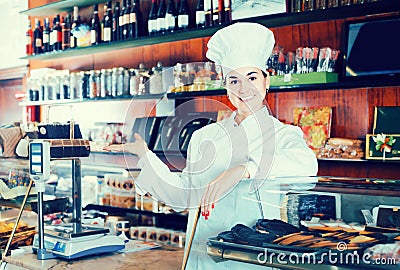 Woman assistant displaying assortment of confectionery Stock Photo