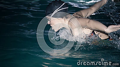 Woman athlete swimming butterfly stroke in pool. Stock Photo