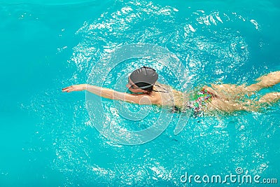 Woman athlete swimming crawl stroke in pool. Stock Photo