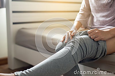 Woman attempt putting or wearing her pant in dressing room Stock Photo