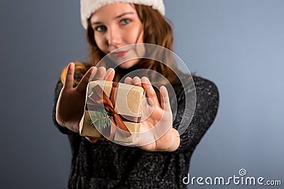 Woman attractive lady wear santa hat. Girl hold box opening christmas gift. Girl celebrate christmas. Girl wear santa claus hat. Stock Photo