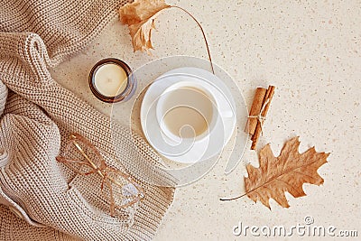 Woman autumn outfit - warm sweater and glasess. Aesthetic coffee time among fall leaves Stock Photo