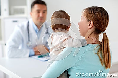 Woman with baby and doctor at clinic Stock Photo