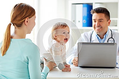 Woman with baby and doctor with laptop at clinic Stock Photo