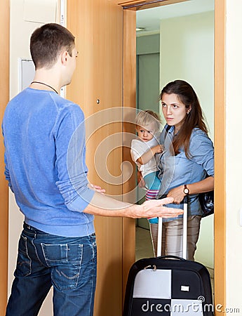 Woman with baby and suitcase Stock Photo