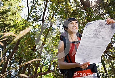 Woman with backpack and map Stock Photo