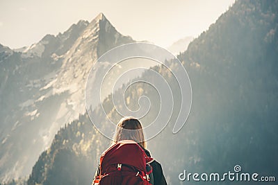 Woman backpacker enjoying rocky mountains view Stock Photo