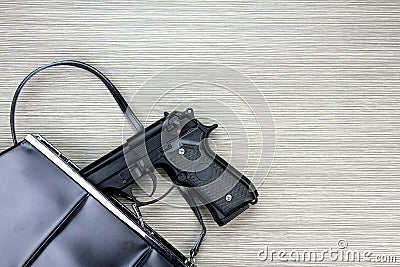 Woman bag with gun hidden, Handgun falling from a woman`s purse. Stock Photo