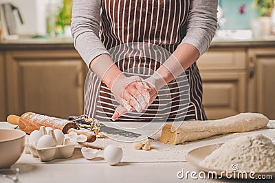 Woman bake pies. Confectioner makes desserts. Making buns. Dough on the table. Knead the dough. Stock Photo